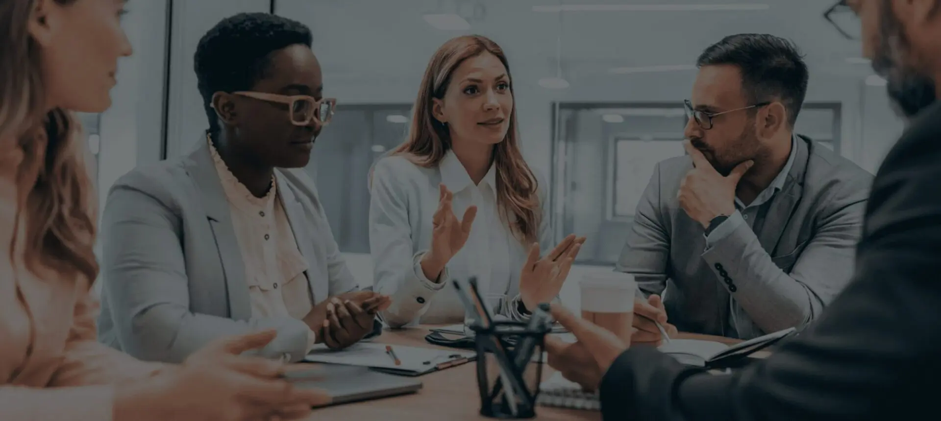 Team discussing ideas in a modern office meeting.