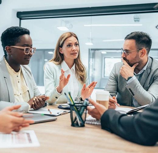 A diverse group engaged in a business meeting, exchanging ideas.