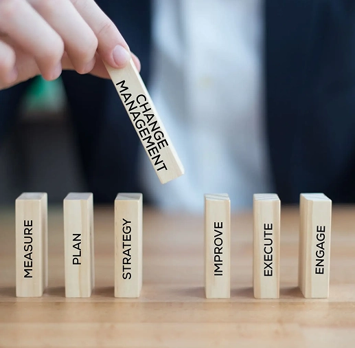Falling blocks labeled with negative traits and a hand stopping 'Management' from falling.